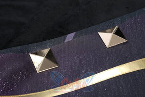 Genshin Impact Xilonen cosplay fabric detail traces silver pyramid studs along a gold-trimmed textile edge.
