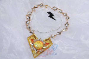 Genshin Impact Xilonen cosplay necklace layers a diamond-set gold chain over a geometric pendant centering an orange stone.