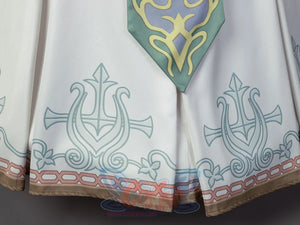 Twilight Princess Zelda cosplay skirt traces teal filigree above a brown patterned border beside a green sash.