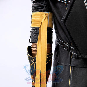 Clair Obscur: Expedition 33 Gustave cosplay arm piece layers gold-trimmed upper armor above long yellow ribbons and bracer.