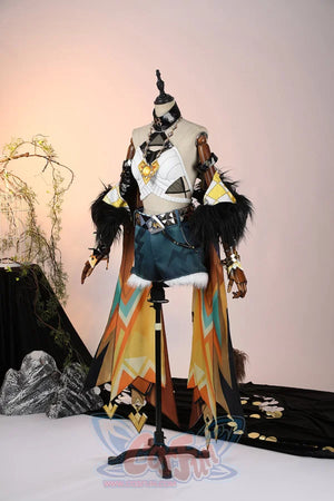 Genshin Impact Xilonen cosplay outfit anchors a flowing shoulder cape over a geometric top and teal-patterned shorts.