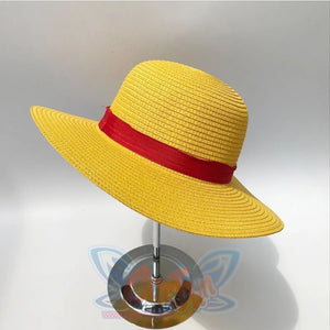 Japanese Anime Monkey D. Luffy cosplay straw hat frames a wide rounded brim anchored by a solid red fabric band.