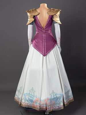 Twilight Princess Zelda cosplay gown traces gold symbol trim along open back above blue-pink-detailed skirt hem.