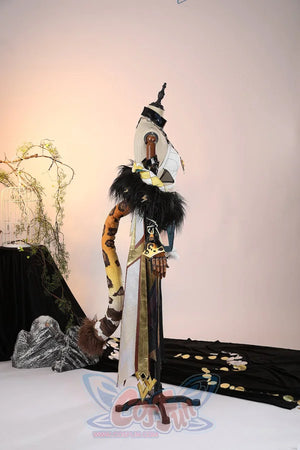 Genshin Impact Xilonen cosplay costume layers a flowy cloak and ornate leg guards over a detailed top from the side.