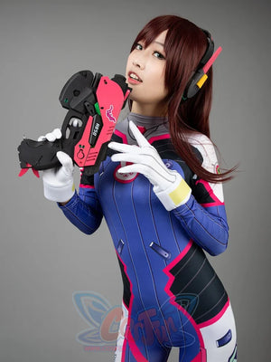 OW D.Va Hana Song cosplay high-neck jumpsuit layers pink stripes and chest logos beside yellow gloves and prop gun.