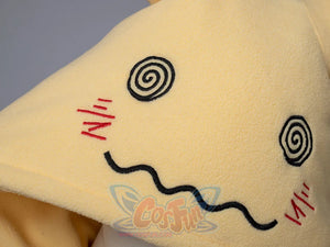 Detail shot of embroidered face design on yellow spark cute cape dress showing cute expression