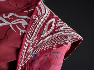 Rhaenyra Targaryen cosplay costume anchors heavy silver embroidered shoulder details over deep maroon brushed cotton fabric.