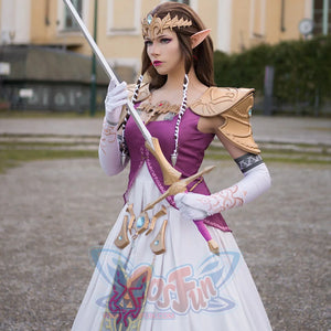 Twilight Princess Zelda cosplay gown pairs white skirt beneath gold tiara and armored pauldrons in full front view.