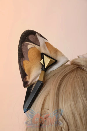 Genshin Impact Xilonen cosplay ear accessory centers a plush cat ear alongside a stylized gold and black dagger ornament.