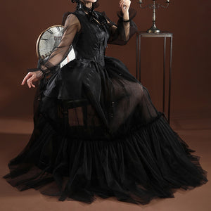 Addams black evening dress worn in dramatic pose showing flowing mesh skirt