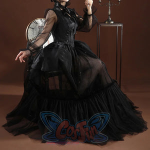 Addams black evening dress worn in dramatic pose showing flowing mesh skirt