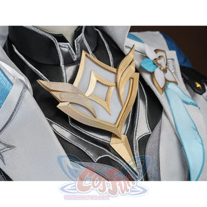 Macro shot of the gold chest emblem on Aether cosplay costume, showing detailed diamond-shaped metallic ornament