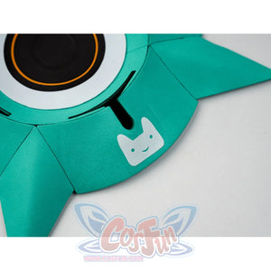 Detail of Aria cosplay costume teal shuriken speaker prop showing cat face logo and orange ring.