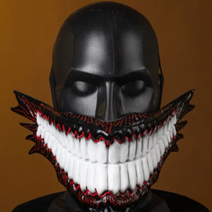 A mannequin dons the Body Party-styled helmet, its menacing jaw, sharp teeth, and dark-red accents creating a stark, eerie vibe against the warm backdrop.