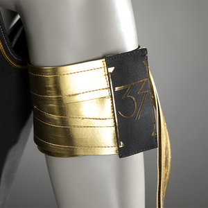 A gold PU leather armband with a black badge bearing the number "33".
