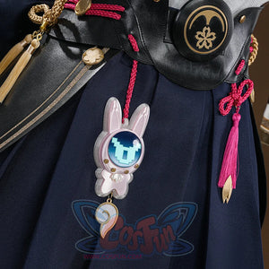 Evanescia cosplay navy hakama with pink rabbit charm, gold coin charms, pink tassel, and black belt with sakura emblem.