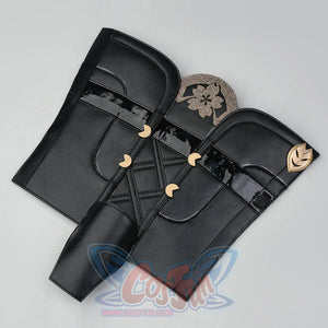 Evanescia cosplay black leather leg guards laid flat, with gold glitter sakura on one and gold leaf ornament on the other.