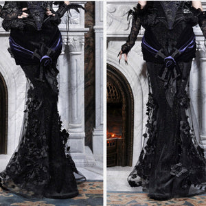Two-angle view of a gothic black mermaid skirt showing floral lace applique on the hem, with a purple velvet sash.