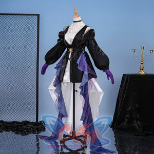 Focuses on the crisscross neckline, gold belt buckle, and layered purple sheers, highlighting intricate front design.