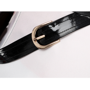Sparkle cosplay belt detail with black patent leather strap and golden rectangular buckle