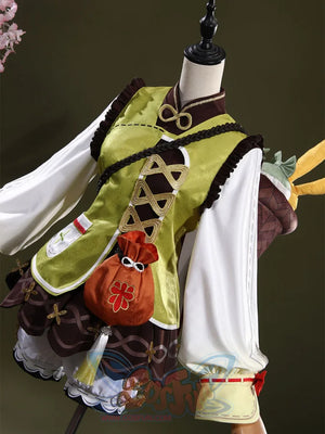 Genshin Impact Yaoyao cosplay outfit anchors green and brown vest over white blouse beside orange pouch and basket backpack.