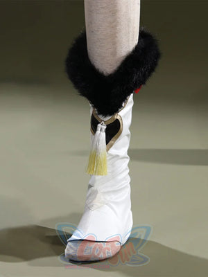 Genshin Impact Yaoyao cosplay boot cover anchors black faux fur cuff beside gold and white tassel and heart emblem.