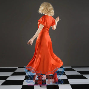Ida cosplay costume back view showing orange satin dress and red heeled boots on checkered floor