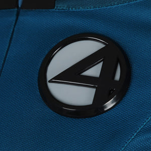 Detailed close-up of Fantastic Four emblem on Sue Storm cosplay costume with textured blue fabric