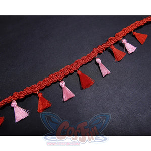 Kid Pennywise costume decorative trim featuring alternating red and pink tassels on braided band
