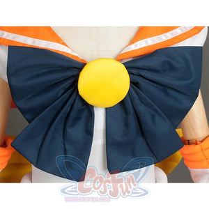 Close - up of the large blue bow with a yellow round center on the front of the costume, showcasing decorative details.