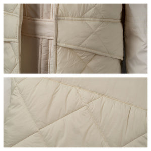 Highlights the quilted pattern of the beige vest. Shows front views of the vest’s fabric and stitching details.