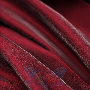 Macro detail of crimson velvet fabric with visible seam stitching from the Miss Pomegranate Little Girl cosplay costume