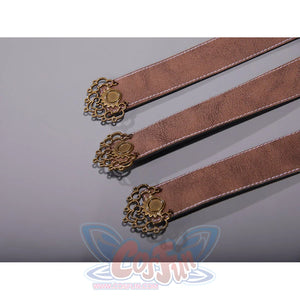 Bloodborne Ludwig cosplay costume three leather straps with ornate antique bronze medallion buckles laid on a surface