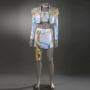 The cosplayer dons a Mira - themed outfit featuring a white crop top, a short jacket with gold epaulets and tassels, a matching skirt with blue patterns and a gold sash, all paired with beige boots, set against a purple backdrop.
