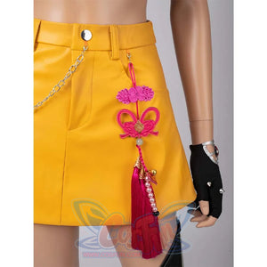 Close - up of an intricate pink ornament with tassels and beads on Mira’s yellow cosplay skirt.