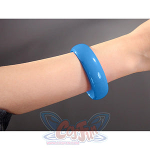 Robin cosplay accessory showing a single blue bangle bracelet worn on a wrist against a gray background