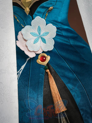 Ruan Mei cosplay costume bodice detail with white plum blossom, gold heart brooch with red gem, and gold tassel.