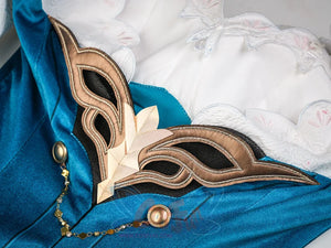 Ruan Mei cosplay costume bronze mask with a gold lotus ornament placed on teal dress, with white lace collar and gold chain.