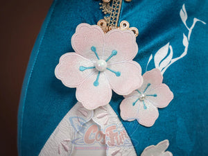 Ruan Mei cosplay costume close-up of pink plum blossom appliques with pearl centers on the teal skirt fabric.