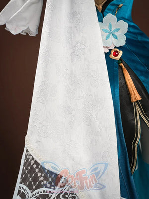 Ruan Mei cosplay costume side view with white floral sleeve, lace hem, teal bodice, red brooch, and gold tassels.