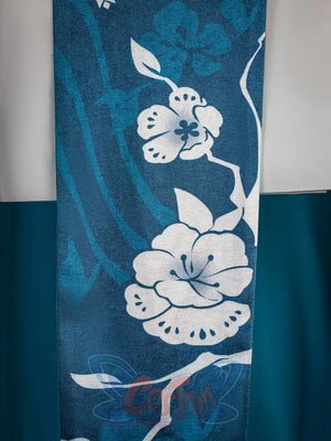 Ruan Mei cosplay costume close-up of the teal skirt panel with white plum blossom embroidery and floral branch motifs.