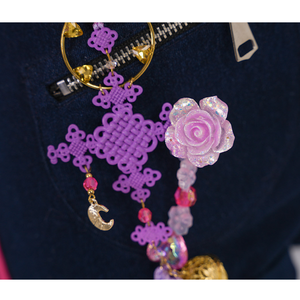 Rumi cosplay costume, pendant featuring a purple ornament, small pink flowers.