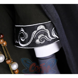 A close-up of the sleeve detail on the Sister Friede cosplay costume, showing the intricate silver embroidery on the dark green fabric.