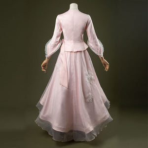 Glinda cosplay costume set featuring pastel pink vintage-inspired gown, ruffled lace cuffs, lace-trimmed sweetheart top, tulle overlay skirt, and necklace. Back side views.