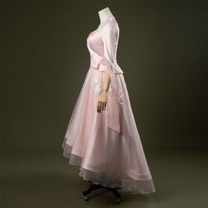 Glinda cosplay costume set featuring pastel pink vintage-inspired gown, ruffled lace cuffs, lace-trimmed sweetheart top, tulle overlay skirt, and necklace. Front and side views.