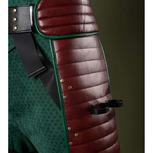 Pants mainly in dark green, accented with gold and reddish-brown tones, black rings on the sides for holding items.