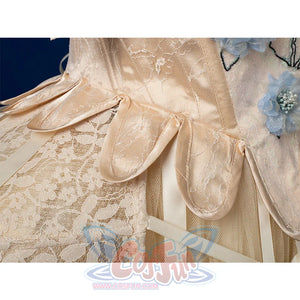 Enid Sinclair Gala dress waist close-up with satin ribbon bows, lace trim, blue floral embroidery, layered tulle texture