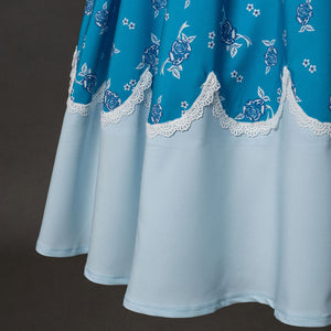 Wheeler cosplay costume skirt detail showing blue floral fabric with white scalloped lace trim