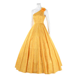 Judy yellow floral dress side angle showing flower accent and flowing pleated design
