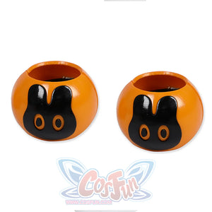 Two orange hair accessories with black bunny designs.